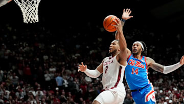 Jan 14, 2025; Tuscaloosa, AL, USA; Alabama guard Chris Youngblood (8) goes for a shot defended by Ole Miss guard Dre Davis (14) at Coleman Coliseum. Ole Miss defeated Alabama 74-64. Mandatory Credit: Gary Cosby Jr.-Tuscaloosa News