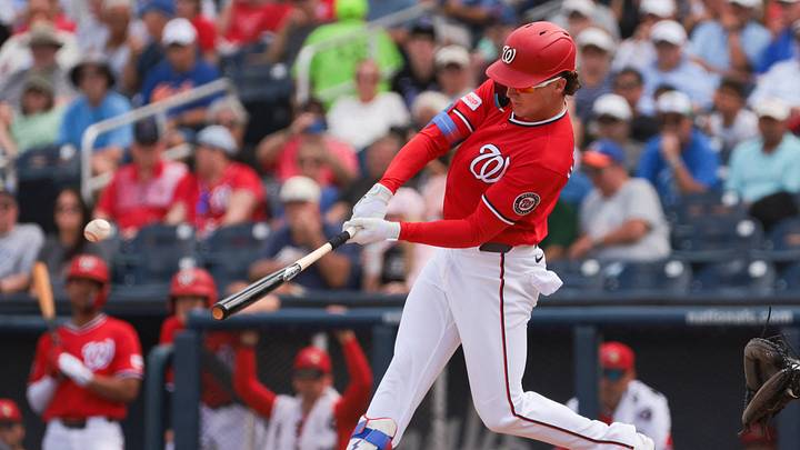 Mar 5, 2026; West Palm Beach, Florida, USA; Washington Nationals center fielder Robert Hassell III (6) hits a single against the New York Mets during the fourth inning at CACTI Park of the Palm Beaches. Mandatory Credit: Sam Navarro-Imagn Images