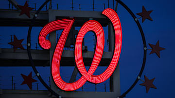 The Curly W, surrounded by 3 Stars on either side.