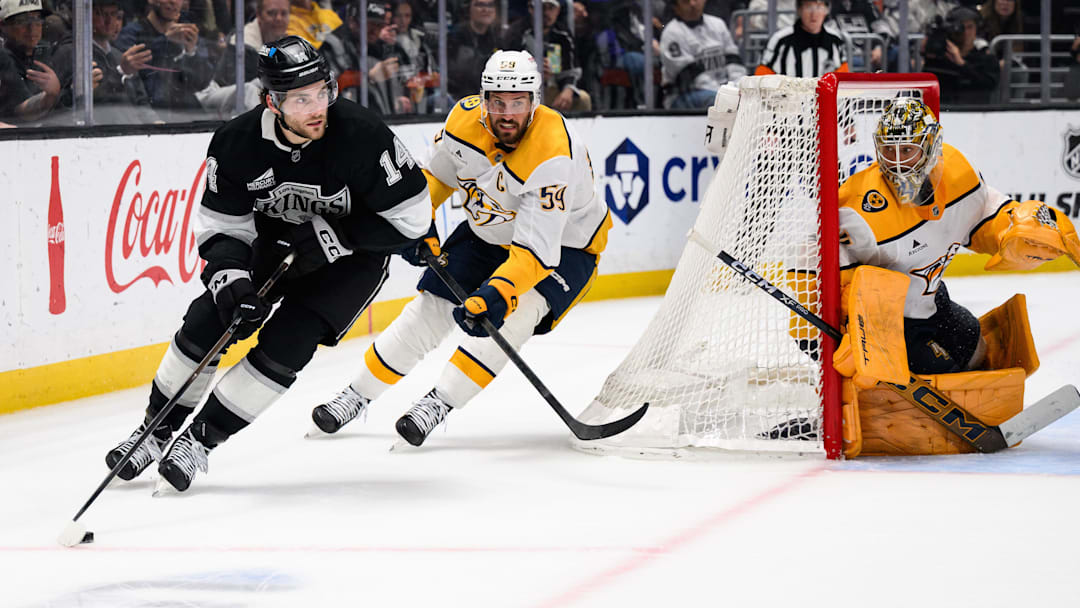 Apr 6, 2026; Los Angeles, California, USA; Los Angeles Kings right wing Alex Laferriere (14) controls the puck while under pressure from Nashville Predators defenseman Roman Josi (59) during overtime at Crypto.com Arena. Mandatory Credit: William Liang-Imagn Images