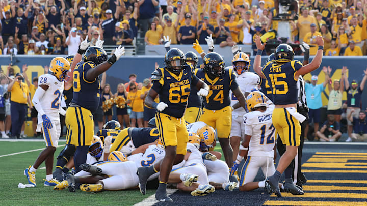 West Virginia celebrates running back Tye Edwards' second touchdown run of the afternoon. West Virginia celebrates running back Tye Edwards' second touchdown run of the afternoon.