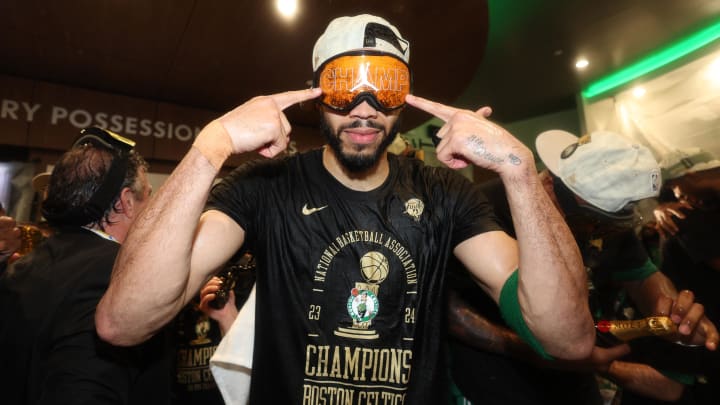 Celtics forward Jayson Tatum celebrates in the locker room after winning the 2024 NBA Finals against the Dallas Mavericks at TD Garden.