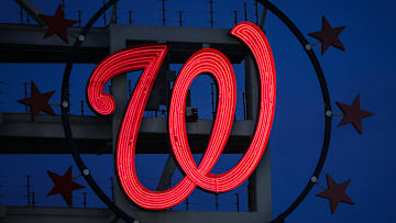 The Curly W, surrounded by 3 Stars on either side.