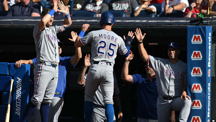 Sep 28, 2025; Cleveland, Ohio, USA;  Texas Rangers second baseman Dylan Moore (25) celebrates after scoring during the second inning against the Cleveland Guardians at Progressive Field. 