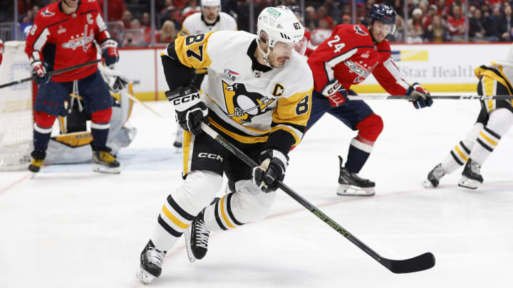 Apr 4, 2024; Washington, District of Columbia, USA; Pittsburgh Penguins center Sidney Crosby (87) skates with the puck as Washington Capitals center Connor McMichael (24) chases in the first period at Capital One Arena. Mandatory Credit: Geoff Burke-USA TODAY Sports