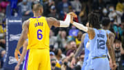 Dec 29, 2021; Memphis, Tennessee, USA; Memphis Grizzlies guard Ja Morant (12) grabs the hand of Los Angeles Lakers forward LeBron James (6) after James makes a three point shot during the second half at the FedExForum. Mandatory Credit: Jerome Miron-USA TODAY Sports