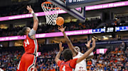 Mar 14, 2025; Nashville, TN, USA;  Mississippi Rebels guard Dre Davis (14) blocks the shot of  Auburn Tigers guard Tahaad Pettiford (0) during the first half at Bridgestone Arena. Mandatory Credit: Steve Roberts-Imagn Images