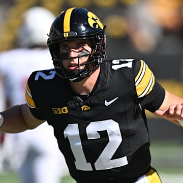 Aug 31, 2024; Iowa City, Iowa, USA; Iowa Hawkeyes quarterback Cade McNamara (12) warms up before the game against the Illinois State Redbirds at Kinnick Stadium. Mandatory Credit: Jeffrey Becker-USA TODAY Sports