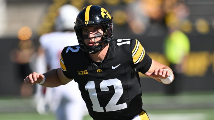 Aug 31, 2024; Iowa City, Iowa, USA; Iowa Hawkeyes quarterback Cade McNamara (12) warms up before the game against the Illinois State Redbirds at Kinnick Stadium. Mandatory Credit: Jeffrey Becker-USA TODAY Sports