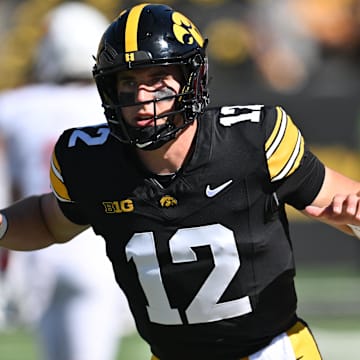 Aug 31, 2024; Iowa City, Iowa, USA; Iowa Hawkeyes quarterback Cade McNamara (12) warms up before the game against the Illinois State Redbirds at Kinnick Stadium.