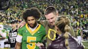 Nov 14, 2025; Eugene, Oregon, USA; Oregon Ducks quarterback Dante Moore (5) and head coach Dan Lanning talk to a reporter after a game against the Minnesota Golden Gophers at Autzen Stadium. Mandatory Credit: Troy Wayrynen-Imagn Images