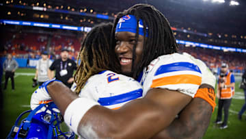Dec 31, 2024; Glendale, AZ, USA; Boise State Broncos running back Jambres Dubar (right) hugs Ashton Jeanty following the game against the Penn State Nittany Lions during the Fiesta Bowl at State Farm Stadium. Mandatory Credit: Mark J. Rebilas-Imagn Images