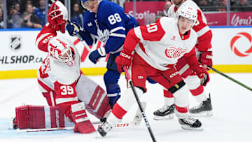 Apr 17, 2025; Toronto, Ontario, CAN; Toronto Maple Leafs right wing William Nylander (88) battles with Detroit Red Wings defenseman Albert Johansson (20) in front of goaltender Cam Talbot (39) during the third period at Scotiabank Arena. Mandatory Credit: Nick Turchiaro-Imagn Images