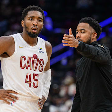 Oct 26, 2024; Washington, District of Columbia, USA; Cleveland Cavaliers guard Donovan Mitchell (45) speaks to Cleveland Cavaliers associate head coach Johnnie
Bryant during a time out in the third quarter against the Washington Wizards at Capital One Arena. Mandatory Credit: Reggie Hildred-Imagn Images