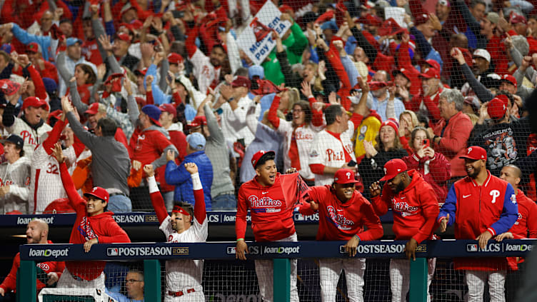 Diego Ettedgui celebrates with Philadelphia Phillies players, NLCS Game 2