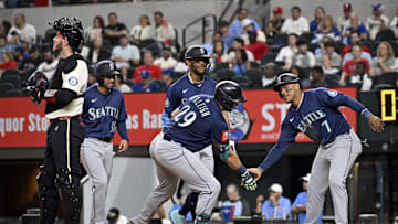 May 2, 2025; Arlington, Texas, USA; Seattle Mariners catcher Cal Raleigh (29) and designated hitter Jorge Polanco (7) and right fielder Rhylan Thomas (31) and center fielder Julio Rodriguez (44) celebrate after Raleigh hits a grand slam against the Texas Rangers during the fifth inning at Globe Life Field. Mandatory Credit: Jerome Miron-Imagn Images