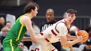 Dec 21, 2024; San Jose, California, USA; Stanford Cardinal forward Maxime Raynaud (right) handles the ball against Oregon Ducks center Nate Bittle (left) during the second half at SAP Center at San Jose. Mandatory Credit: Darren Yamashita-Imagn Images