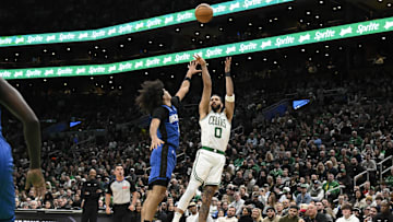 Jan 17, 2025; Boston, Massachusetts, USA; Boston Celtics forward Jayson Tatum (0) shoots the ball over Orlando Magic guard Anthony Black (0) during the second half at TD Garden. Mandatory Credit: Eric Canha-Imagn Images