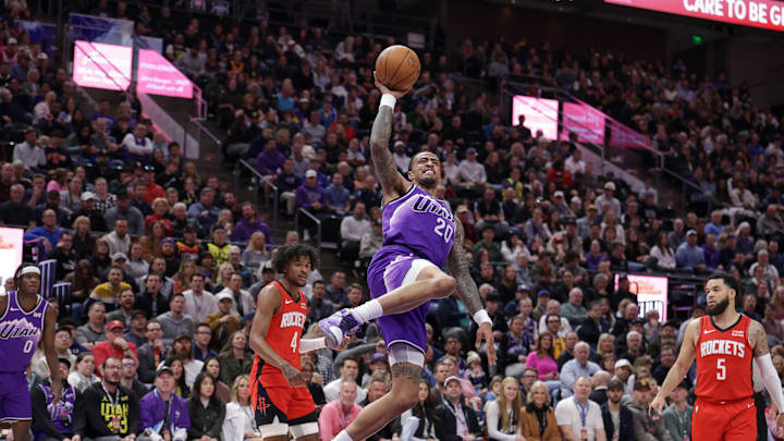 Mar 29, 2024; Salt Lake City, Utah, USA;  Utah Jazz forward John Collins (20) is fouled while shooting the ball during the first quarter at Delta Center. Mandatory Credit: Chris Nicoll-Imagn Images