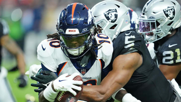 Jan 7, 2024; Paradise, Nevada, USA; Denver Broncos wide receiver Jerry Jeudy (10) is tackled by Las Vegas Raiders linebacker Divine Deablo (5) during the fourth quarter at Allegiant Stadium. Mandatory Credit: Stephen R. Sylvanie-USA TODAY Sports