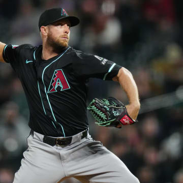 Apr 9, 2024; Denver, Colorado, USA; Arizona Diamondbacks starting pitcher Merrill Kelly (29) delivers a pitch in the fifth inning against the Colorado Rockies at Coors Field. Mandatory Credit: Ron Chenoy-USA TODAY Sports