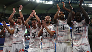 Bayern Munich players celebrating with travelling fans in Paris after beating Paris Saint-Germain.