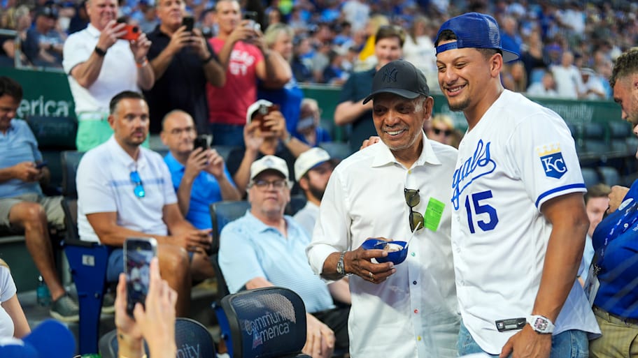 Kansas City Chiefs QB Patrick Mahomes poses for a picture with Hall of Famer Reggie Jackson at the Kansas City Royals game. | Jay Biggerstaff/Getty Images