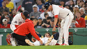 May 2, 2025; Boston, Massachusetts, USA; Boston Red Sox first baseman Triston Casas (36) is attended to by coaching and medical staff during the second inning against the Minnesota Twins at Fenway Park. Mandatory Credit: Eric Canha-Imagn Images