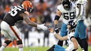 Dec 10, 2023; Cleveland, Ohio, USA; Cleveland Browns defensive end Myles Garrett (95) lends a hand to help up Jacksonville Jaguars quarterback Trevor Lawrence (16) during the fourth quarter at Cleveland Browns Stadium. Mandatory Credit: Scott Galvin-Imagn Images