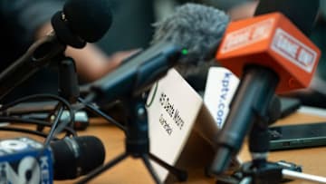 Microphones sit on the table as Oregon quarterback Dante Moore speaks during Oregon football’s Media Day on July 28, 2025, at Autzen Stadium in Eugene.