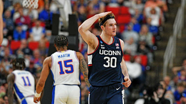 Mar 23, 2025; Raleigh, NC, USA; Connecticut Huskies forward Liam McNeeley (30) reacts after scoring a basket during the secon
