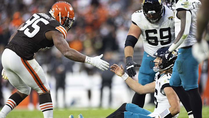 Dec 10, 2023; Cleveland, Ohio, USA; Cleveland Browns defensive end Myles Garrett (95) lends a hand to help up Jacksonville Jaguars quarterback Trevor Lawrence (16) during the fourth quarter at Cleveland Browns Stadium. Mandatory Credit: Scott Galvin-Imagn Images