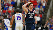 Mar 23, 2025; Raleigh, NC, USA; Connecticut Huskies forward Liam McNeeley (30) reacts after scoring a basket during the second half against the Florida Gators in the second round of the NCAA Tournament at Lenovo Center. Mandatory Credit: Zachary Taft-Imagn Images