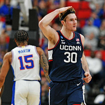 Mar 23, 2025; Raleigh, NC, USA; Connecticut Huskies forward Liam McNeeley (30) reacts after scoring a basket during the second half against the Florida Gators in the second round of the NCAA Tournament at Lenovo Center. Mandatory Credit: Zachary Taft-Imagn Images