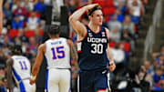 Mar 23, 2025; Raleigh, NC, USA; Connecticut Huskies forward Liam McNeeley (30) reacts after scoring a basket during the second half against the Florida Gators in the second round of the NCAA Tournament at Lenovo Center. Mandatory Credit: Zachary Taft-Imagn Images