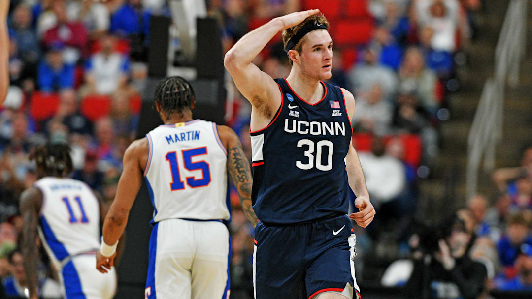 Mar 23, 2025; Raleigh, NC, USA; Connecticut Huskies forward Liam McNeeley (30) reacts after scoring a basket during the second half against the Florida Gators in the second round of the NCAA Tournament at Lenovo Center. 