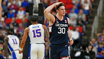 Mar 23, 2025; Raleigh, NC, USA; Connecticut Huskies forward Liam McNeeley (30) reacts after scoring a basket during the second half against the Florida Gators in the second round of the NCAA Tournament at Lenovo Center. 
