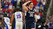 Mar 23, 2025; Raleigh, NC, USA; Connecticut Huskies forward Liam McNeeley (30) reacts after scoring a basket during the second half against the Florida Gators in the second round of the NCAA Tournament at Lenovo Center. Mandatory Credit: Zachary Taft-Imagn Images