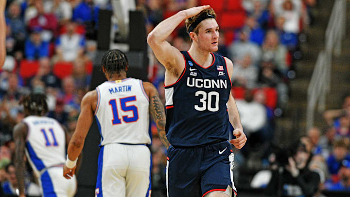 Mar 23, 2025; Raleigh, NC, USA; Connecticut Huskies forward Liam McNeeley (30) reacts after scoring a basket during the second half against the Florida Gators in the second round of the NCAA Tournament at Lenovo Center. Mandatory Credit: Zachary Taft-Imagn Images