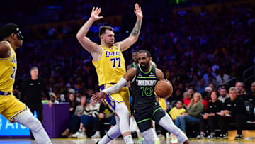 Apr 30, 2025; Los Angeles, California, USA; Minnesota Timberwolves guard Mike Conley (10) moves the ball against Los Angeles Lakers guard Luka Doncic (77) during the second half in game five of first round for the 2025 NBA Playoffs at Crypto.com Arena. Mandatory Credit: Gary A. Vasquez-Imagn Images