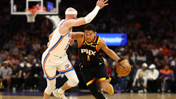 Apr 9, 2025; Phoenix, Arizona, USA; Phoenix Suns guard Devin Booker (1) dribbles the ball against  Oklahoma City Thunder guard Alex Caruso (9) during the first half at Footprint Center. Mandatory Credit: Mark J. Rebilas-Imagn Images