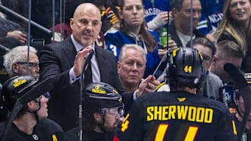 Mar 7, 2025; Vancouver, British Columbia, CAN; Vancouver Canucks head coach Rick Tocchet talks with forward Kiefer Sherwood (44) on the bench against the Minnesota Wild in the third period at Rogers Arena. Mandatory Credit: Bob Frid-Imagn Images