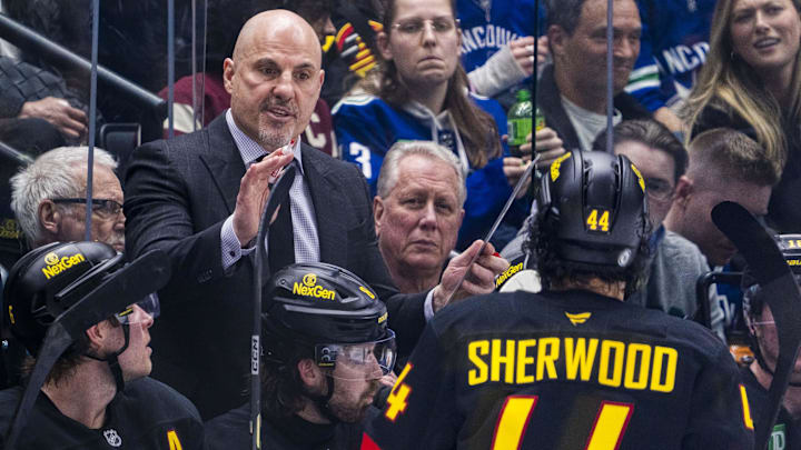 Mar 7, 2025; Vancouver, British Columbia, CAN; Vancouver Canucks head coach Rick Tocchet talks with forward Kiefer Sherwood (44) on the bench against the Minnesota Wild in the third period at Rogers Arena. Mandatory Credit: Bob Frid-Imagn Images