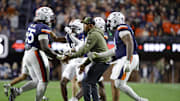 Nov 8, 2025; Charlottesville, Virginia, USA; Virginia Cavaliers head coach Tony Elliott (center) celebrates with players after a play against the Wake Forest Demon Deacons during the first half at Scott Stadium. Mandatory Credit: Amber Searls-Imagn Images