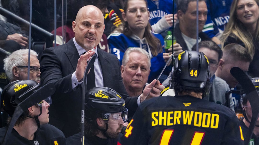 Mar 7, 2025; Vancouver, British Columbia, CAN; Vancouver Canucks head coach Rick Tocchet talks with forward Kiefer Sherwood (44) on the bench against the Minnesota Wild in the third period at Rogers Arena.