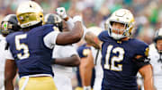 Notre Dame defensive lineman Jordan Botelho (12) and defensive lineman Boubacar Traore (5) celebrate getting a stop during the first half of a NCAA football game against Purdue at Notre Dame Stadium on Saturday, Sept. 20, 2025, in South Bend.