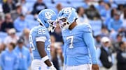 Oct 25, 2025; Chapel Hill, North Carolina, USA; North Carolina Tar Heels running back Benjamin Hall (28) with quarterback Gio Lopez (7) on the field in the third quarter at Kenan Stadium. Mandatory Credit: Bob Donnan-Imagn Images