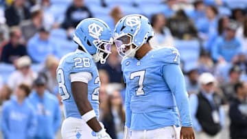 Oct 25, 2025; Chapel Hill, North Carolina, USA; North Carolina Tar Heels running back Benjamin Hall (28) with quarterback Gio Lopez (7) on the field in the third quarter at Kenan Stadium. Mandatory Credit: Bob Donnan-Imagn Images