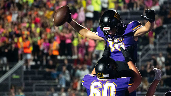 Waukee's Lucas Peterson (16) celebrates a touchdown with Colt Schipper (60) during a game between Waukee and Sioux City North on Friday, Sept. 13, 2024, in Waukee.