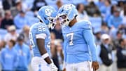 Oct 25, 2025; Chapel Hill, North Carolina, USA; North Carolina Tar Heels running back Benjamin Hall (28) with quarterback Gio Lopez (7) on the field in the third quarter at Kenan Stadium. Mandatory Credit: Bob Donnan-Imagn Images